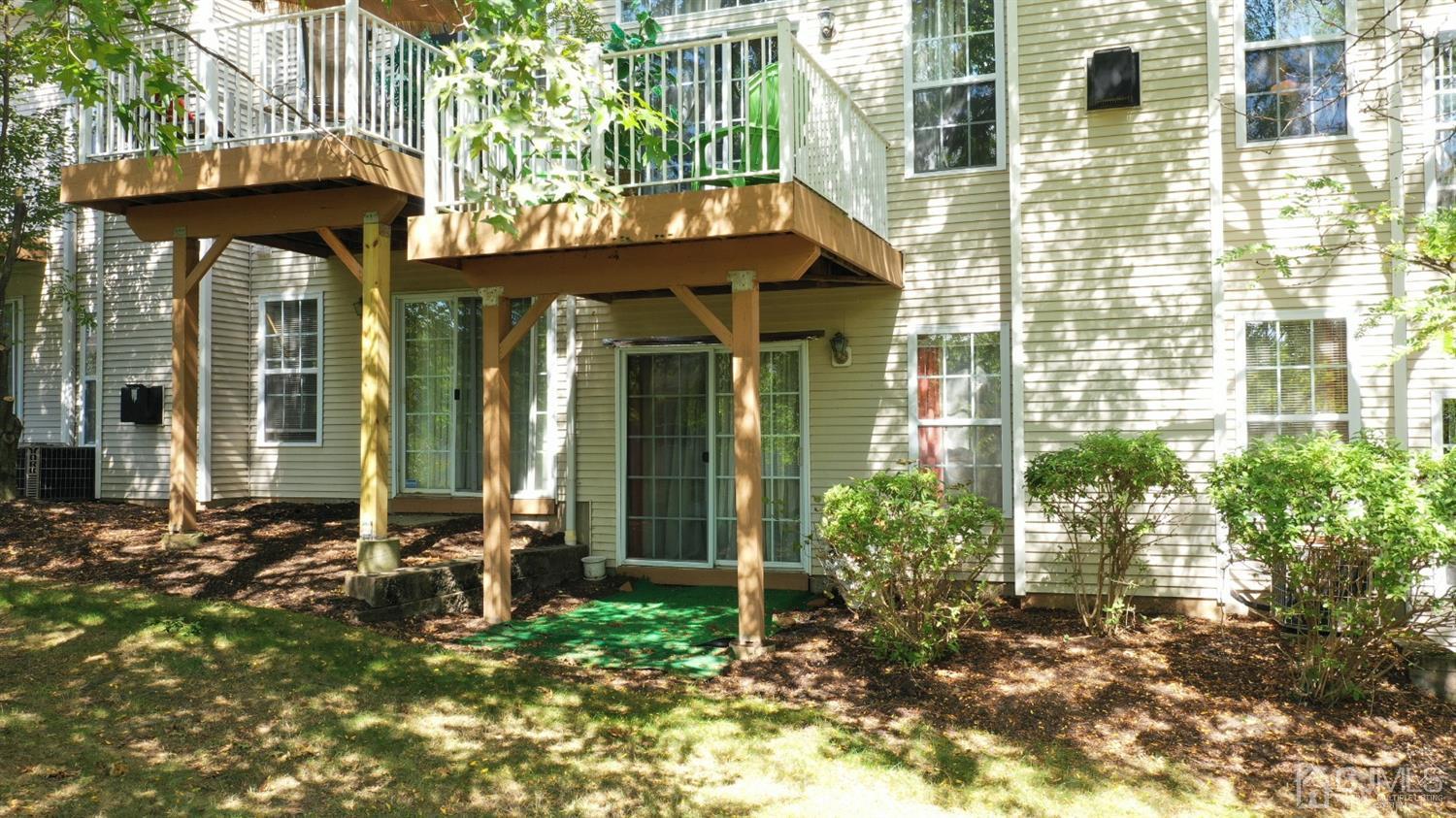 1069 Shadowlawn Drive, Unit 604 Green Brook, NJ 08812 - Photo 39 of 45 a view of a brick house with a large windows and plants