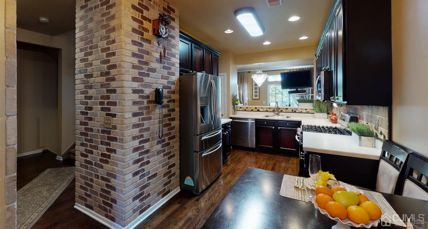 1069 Shadowlawn Drive, Unit 604 Green Brook, NJ 08812 - Photo 4 of 45 a kitchen with sink refrigerator and microwave