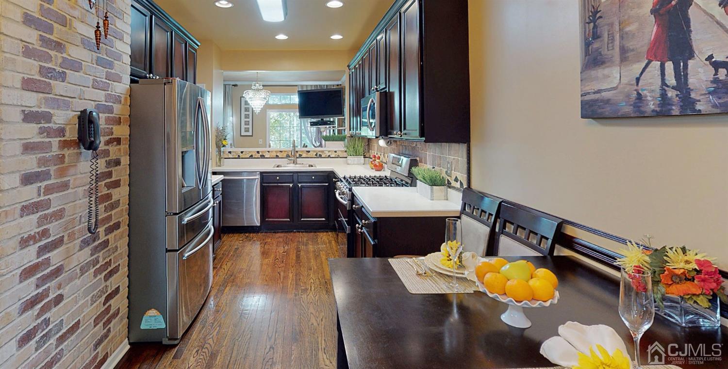 1069 Shadowlawn Drive, Unit 604 Green Brook, NJ 08812 - Photo 10 of 45 a kitchen with stainless steel appliances granite countertop a sink dishwasher stove and cabinets