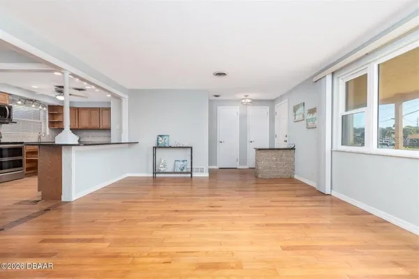 a living room with furniture and a wooden floor