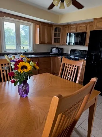 a kitchen with a table chairs sink and window