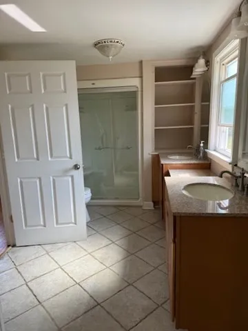 a bathroom with a sink toilet and shower