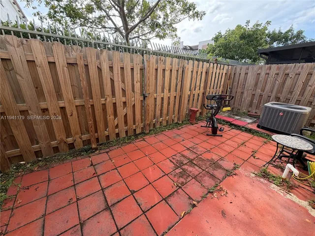 a view of a backyard with wooden fence