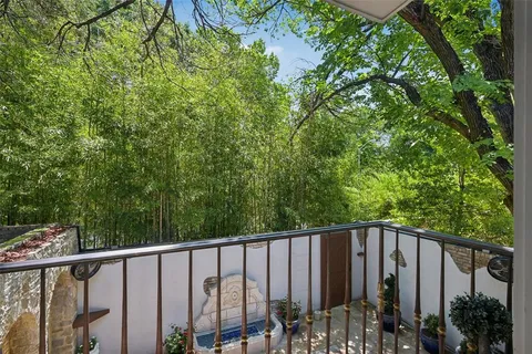 a view of a wooden fence and trees