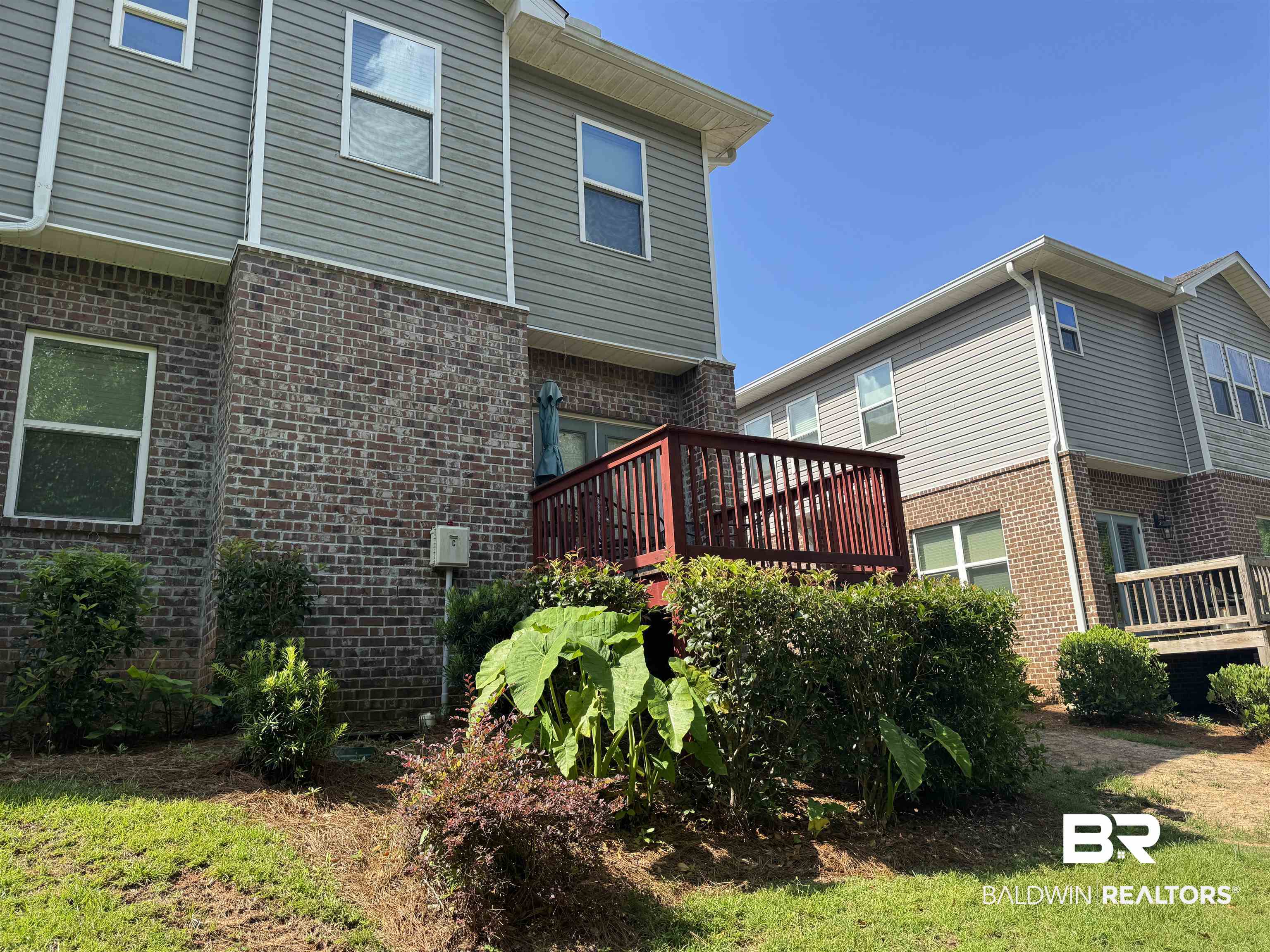 6811 Spaniel Drive, Unit C Daphne, AL 36527 - Photo 7 of 33 Back of house featuring brick siding and a deck