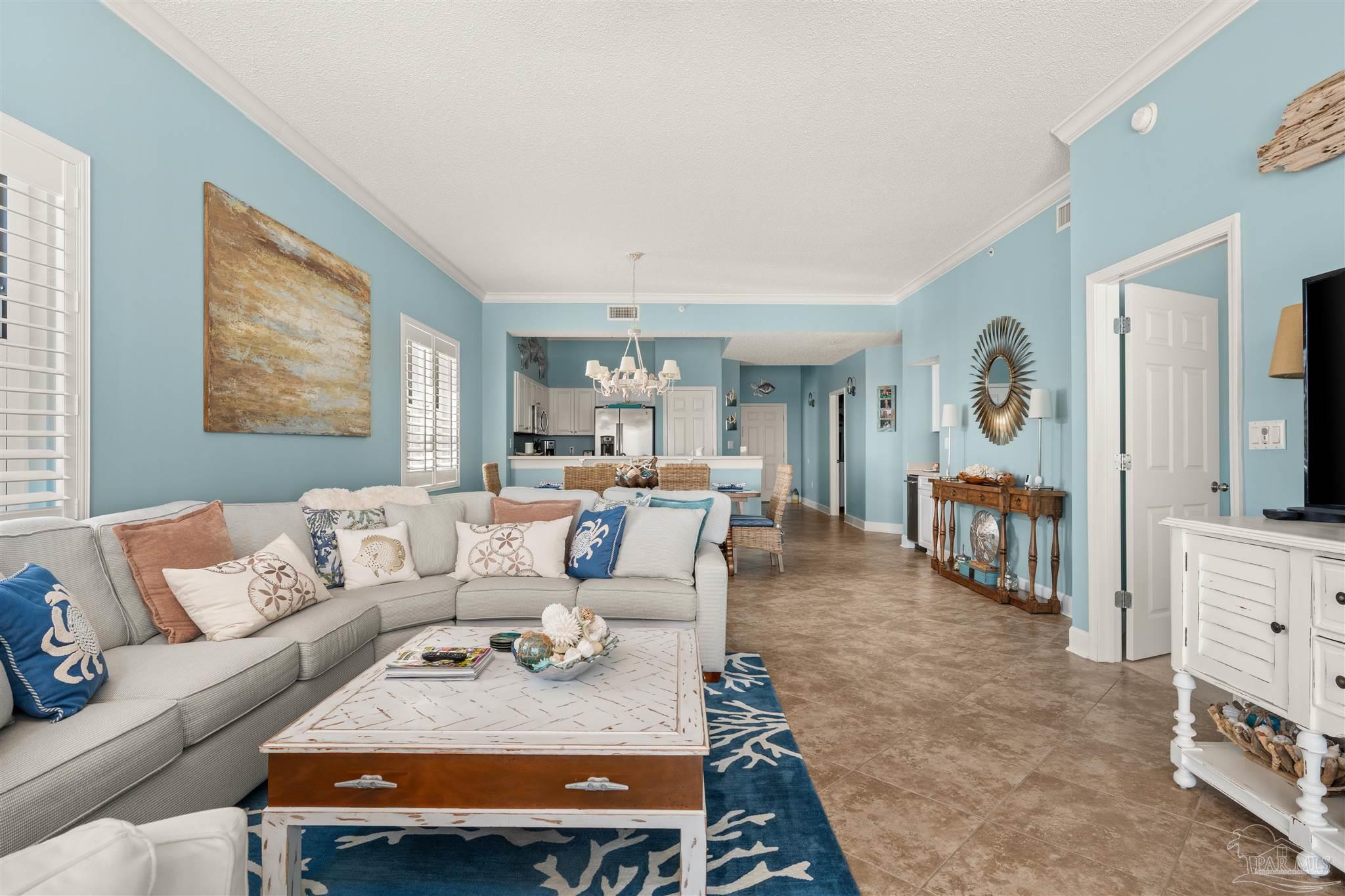 14511 Perdido Key Drive, Unit 508 Perdido Key, FL 32507 - Photo 18 of 59 a living room with furniture a couch and paintings on the wall