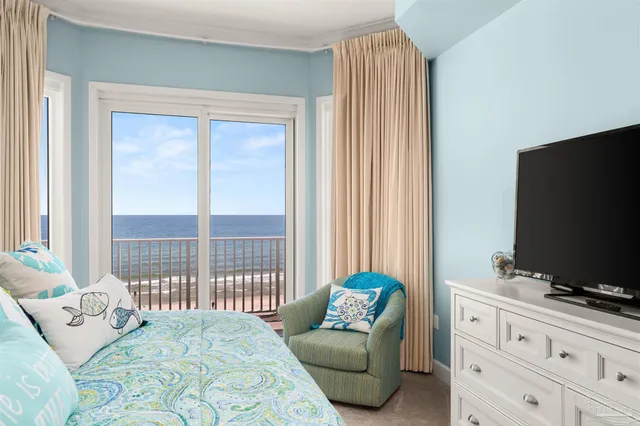 a bedroom with a bed and a television