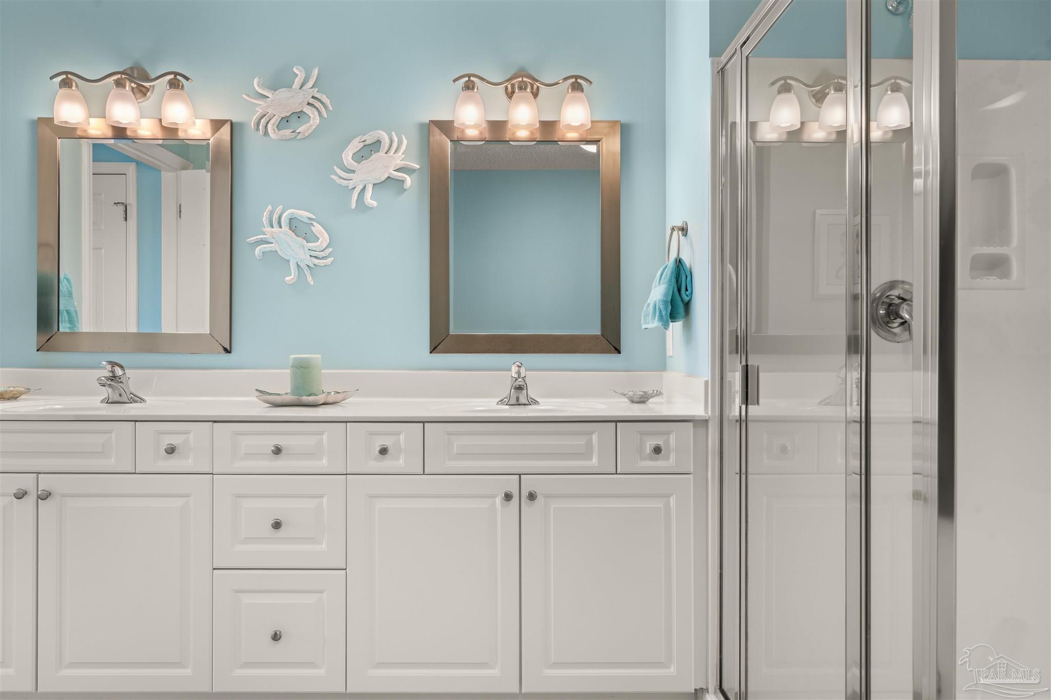 14511 Perdido Key Drive, Unit 508 Perdido Key, FL 32507 - Photo 24 of 59 a bathroom with double vanity sinks a vanity a lamp and a mirror