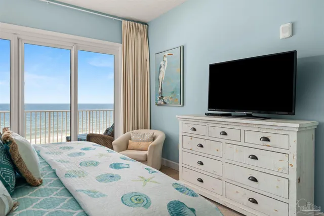 a bedroom with a bed and a television