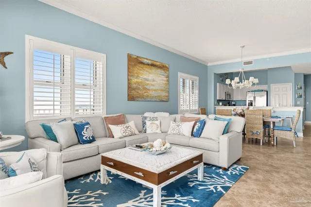 a living room with furniture a rug and a window