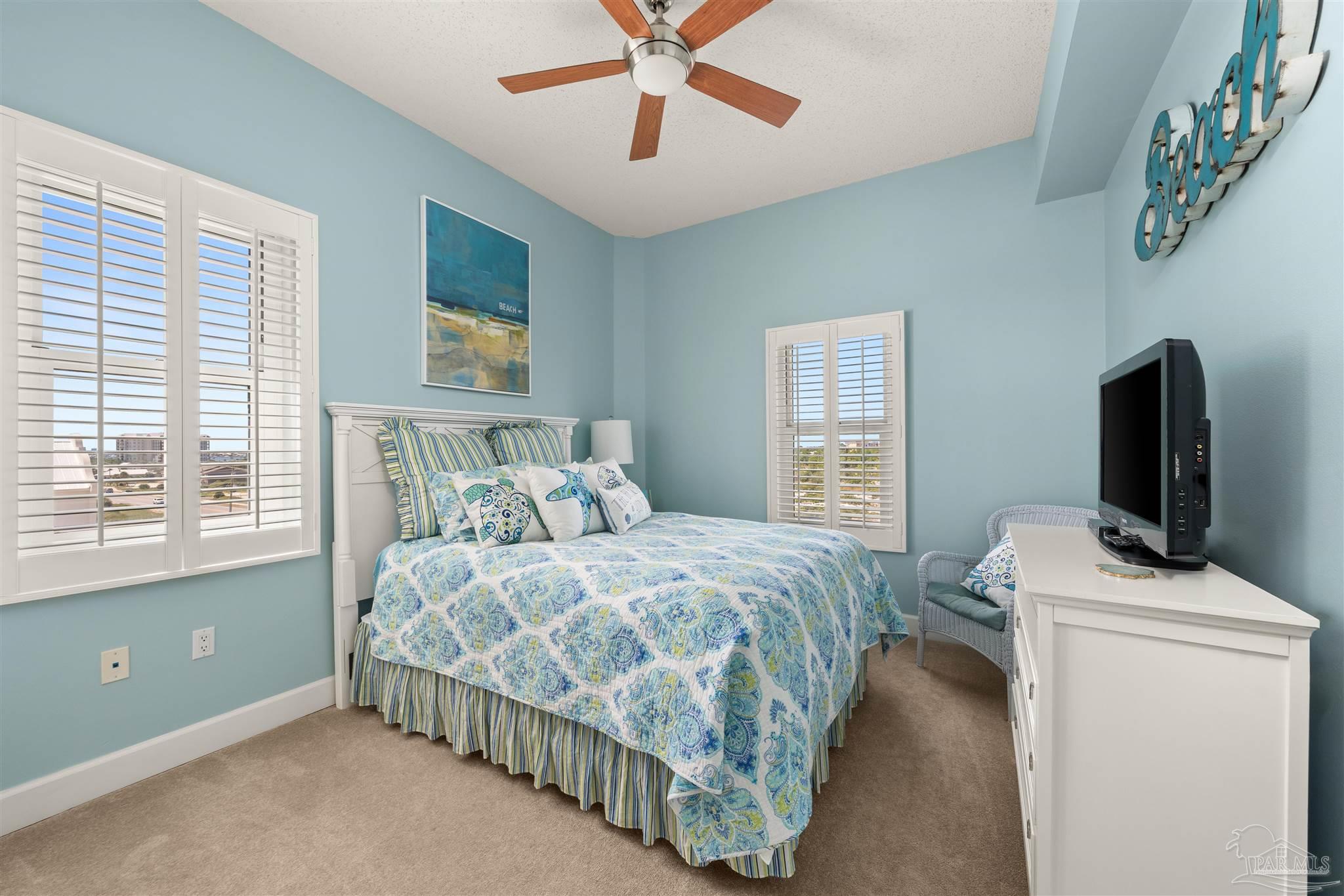 14511 Perdido Key Drive, Unit 508 Perdido Key, FL 32507 - Photo 33 of 59 a bedroom with a bed and a flat tv screen on dresser