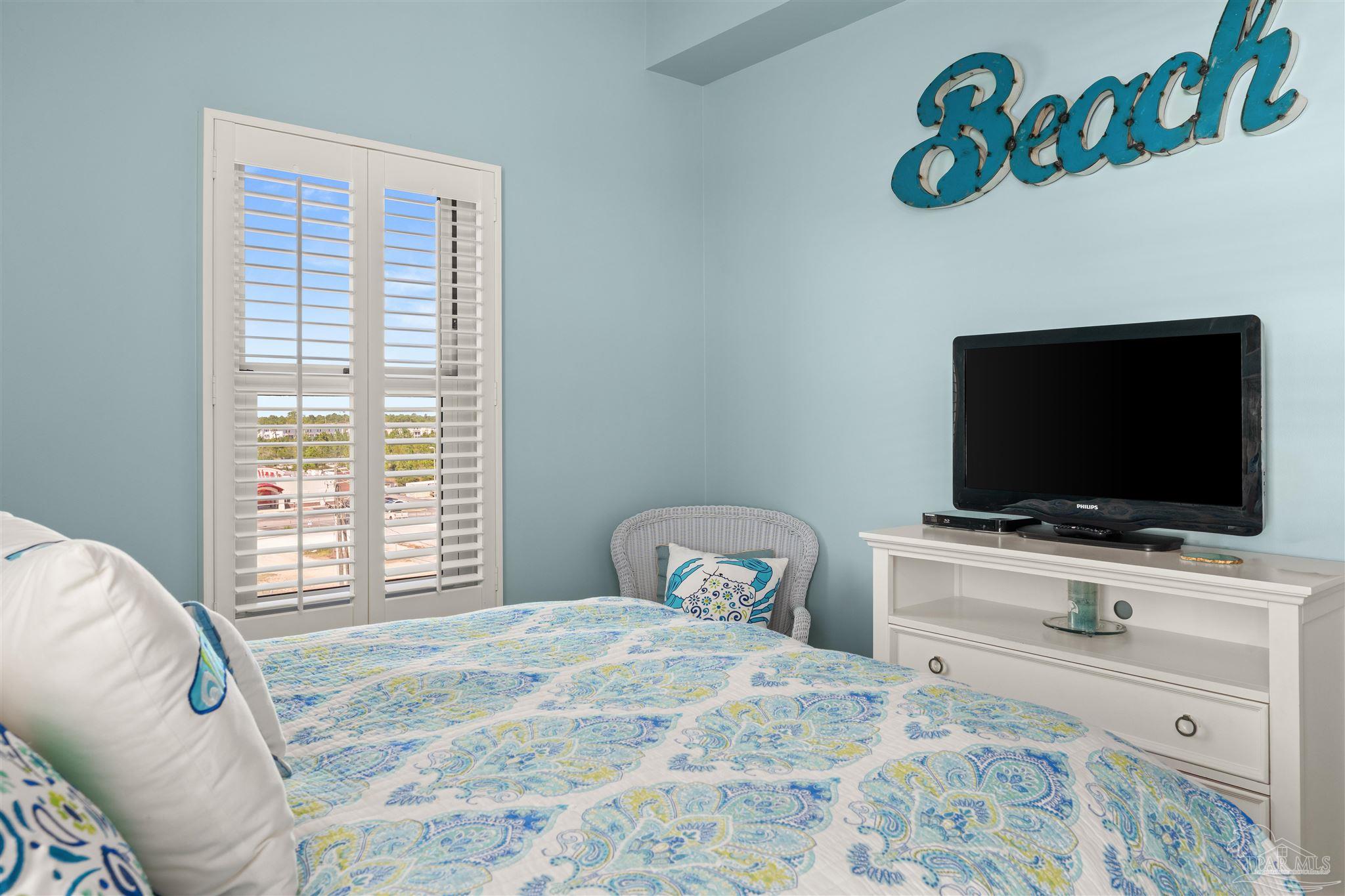14511 Perdido Key Drive, Unit 508 Perdido Key, FL 32507 - Photo 34 of 59 a bedroom with a bed and a flat screen tv