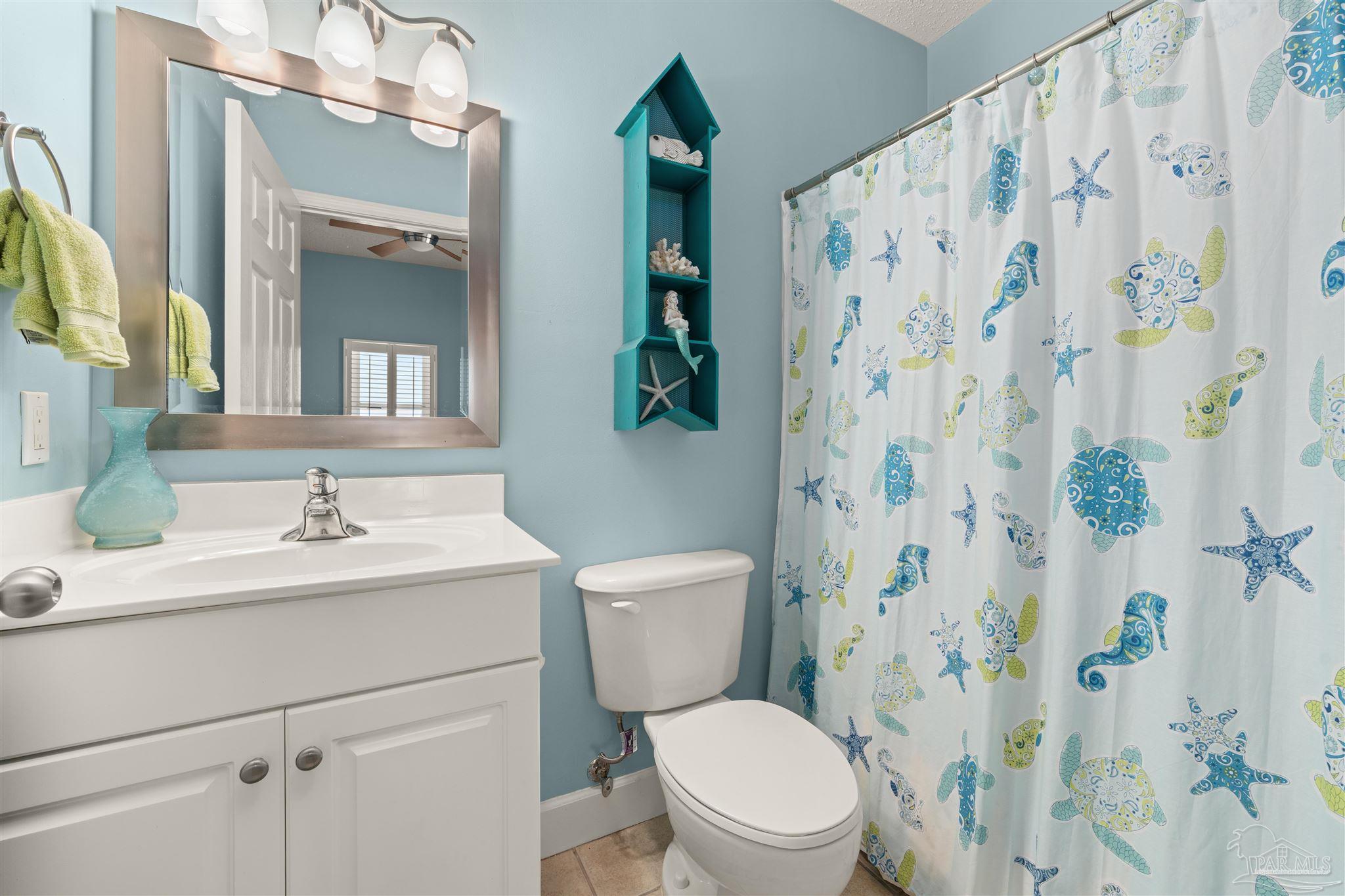 14511 Perdido Key Drive, Unit 508 Perdido Key, FL 32507 - Photo 36 of 59 a bathroom with a sink a toilet and a mirror