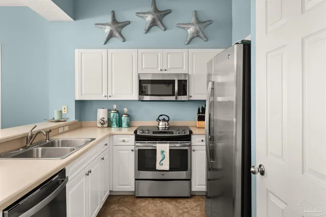a kitchen with a sink stove and microwave