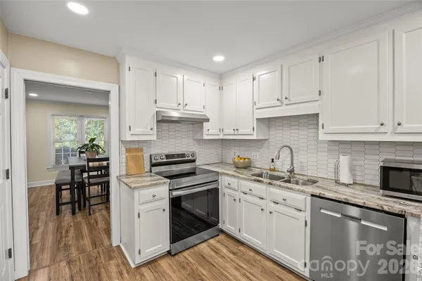 a kitchen that has a sink and a stove in it
