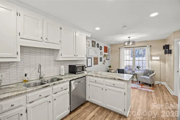 a kitchen with stainless steel appliances a refrigerator sink and microwave
