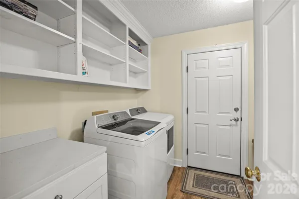 a utility room with cabinets washer and dryer