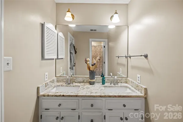 a bathroom with a toilet and a shower curtain