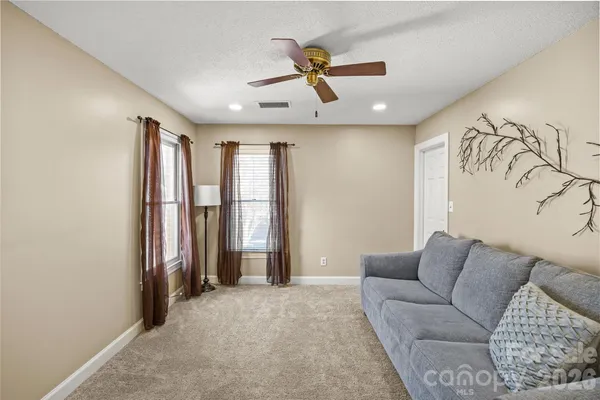 a view of livingroom with a ceiling fan and window