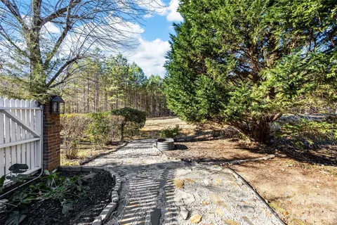 a view of a house with a small yard and plants