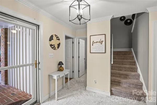 a view of a hallway with wooden floor and workspace