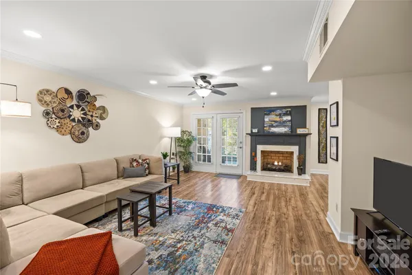 a living room with furniture and a chandelier