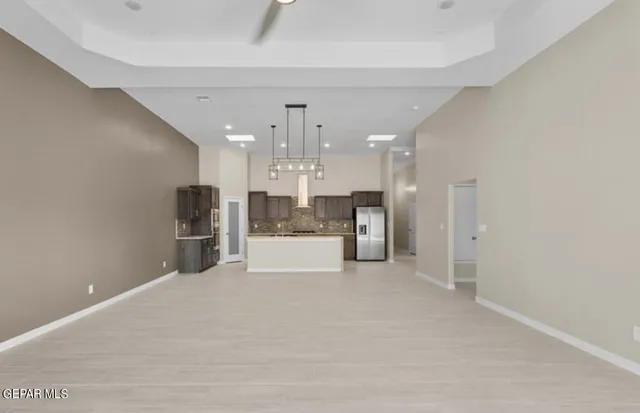 a view of kitchen with refrigerator and window