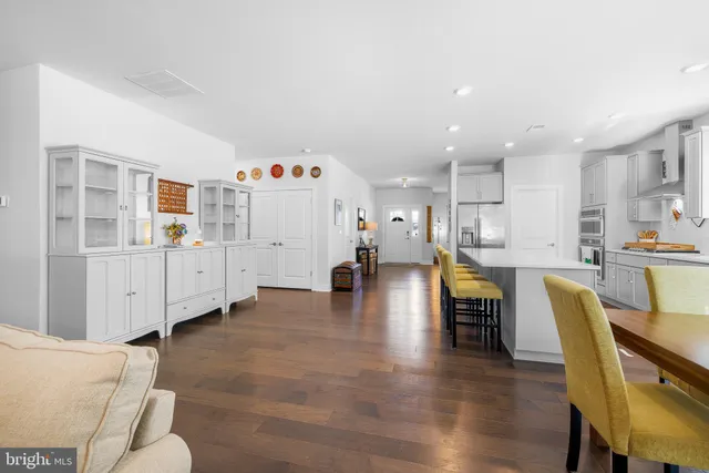 a living room with furniture and kitchen view