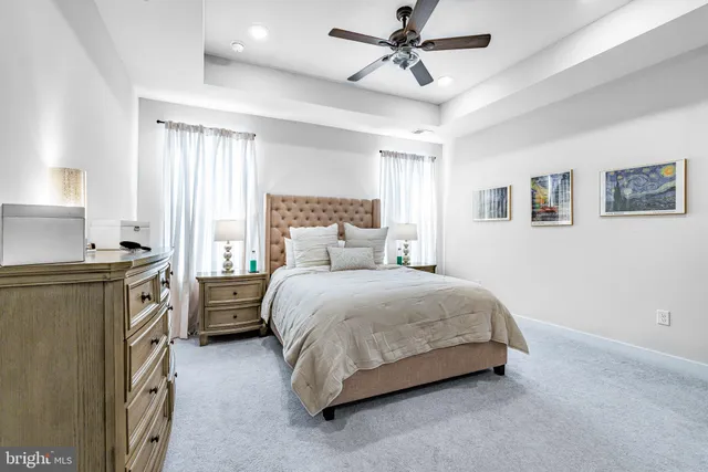 a bedroom with a bed dresser and a window