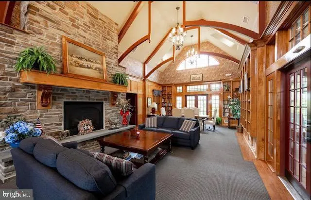 a living room with furniture a fireplace and a chandelier
