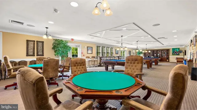 a view of a dining room with furniture a chandelier and wooden floor