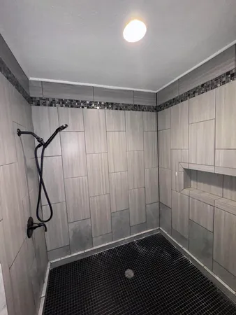 a bathroom with a shower and a shower