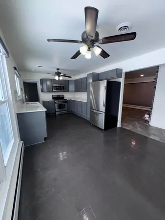 a view of a livingroom with furniture and a ceiling fan