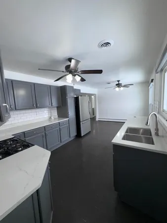 a kitchen that has a sink and a stove