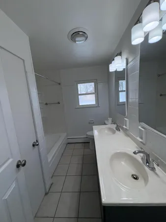 a bathroom with a sink a toilet and mirror