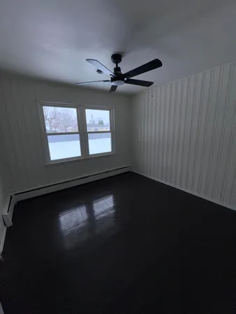 a view of room with hardwood floor and window