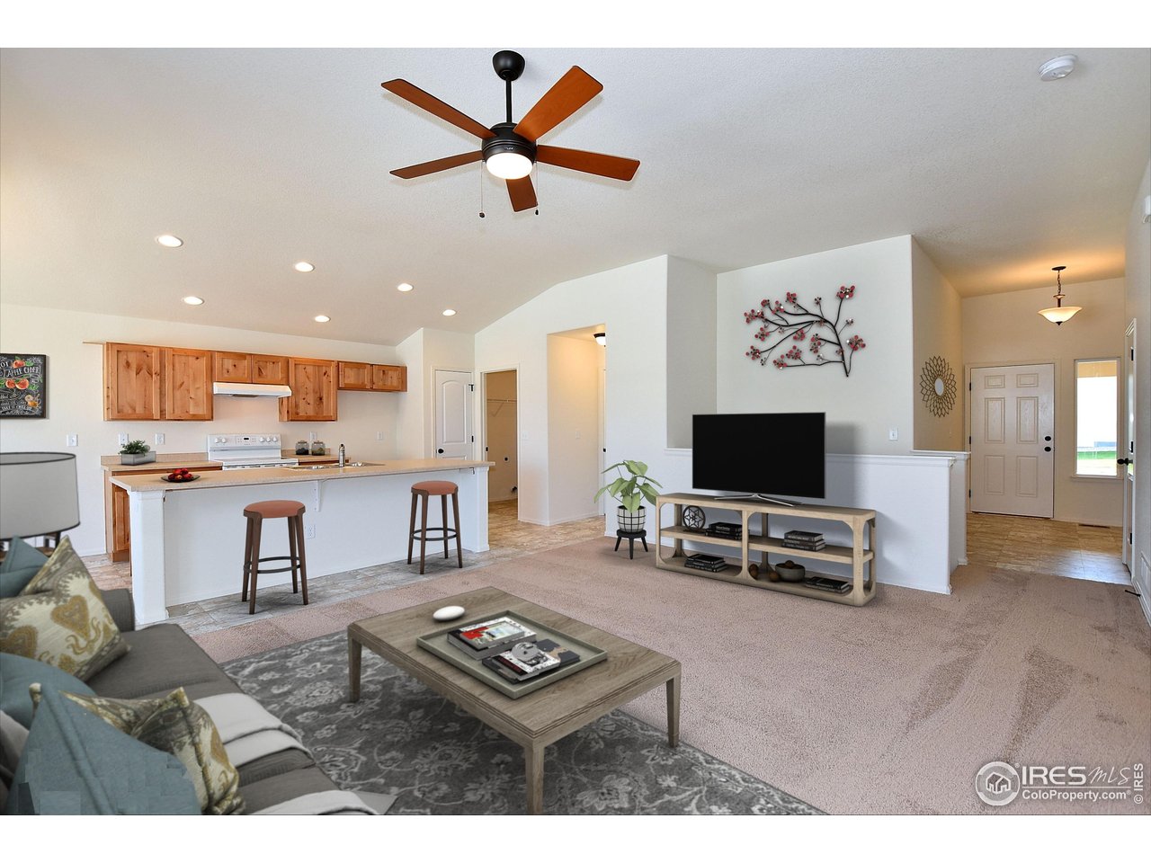 612 87th Avenue Greeley, CO 80634 - Photo 4 of 37 a living room with furniture and a flat screen tv