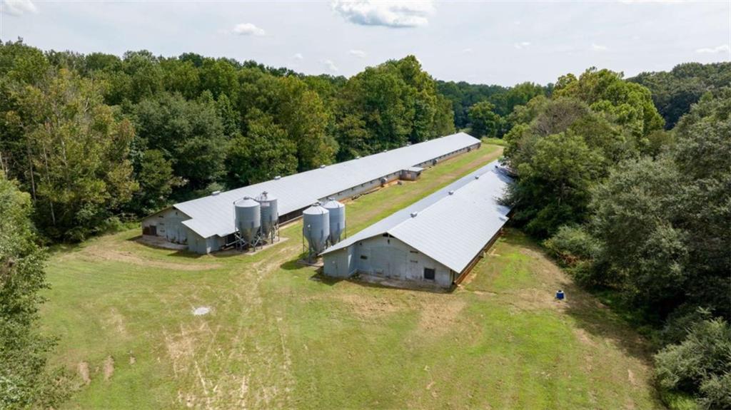 a view of a house with pool and a yard