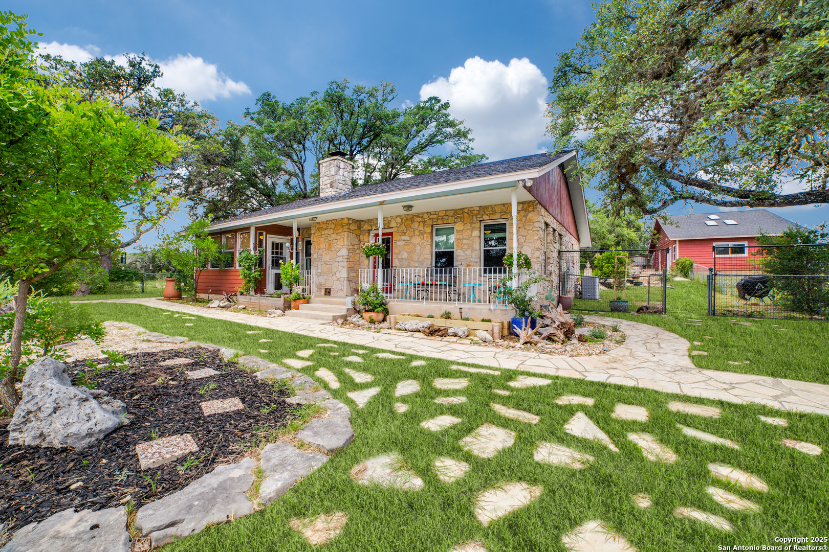 20892 Bluehill Pass Helotes, TX 78023 - Photo 1 of 36 a view of a patio with table and chairs potted plants and large tree
