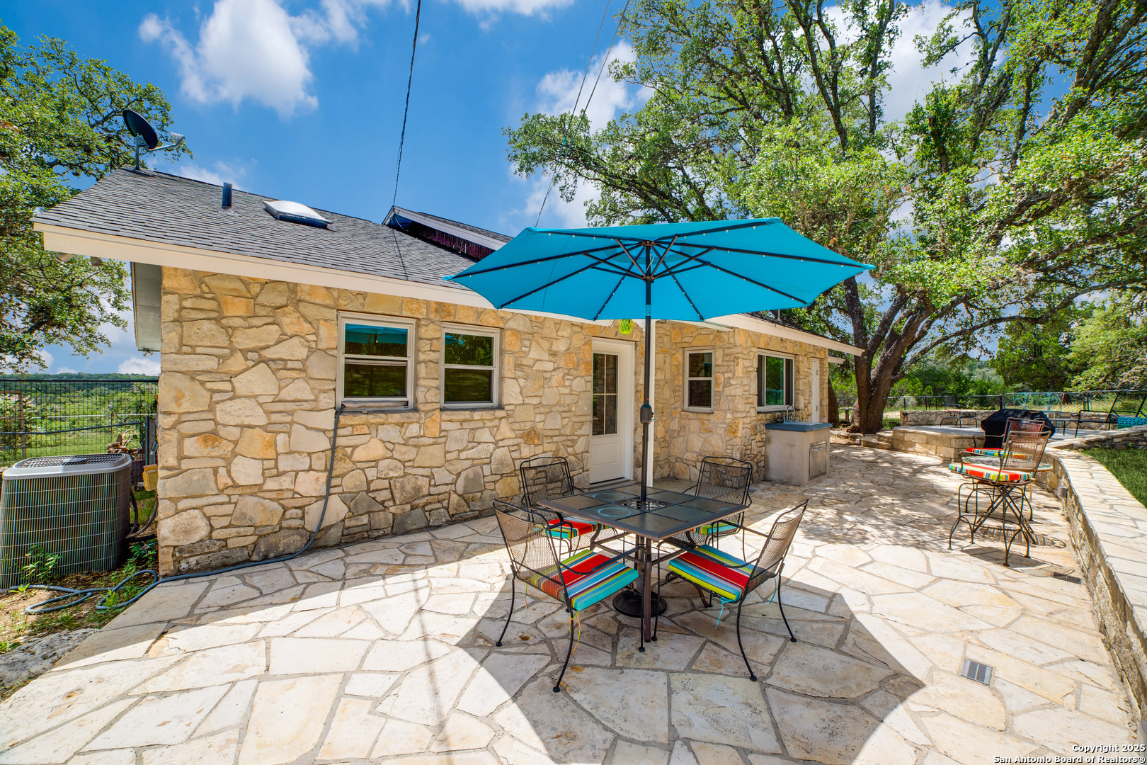 20892 Bluehill Pass Helotes, TX 78023 - Photo 20 of 36 a view of a patio with a table and chairs under an umbrella