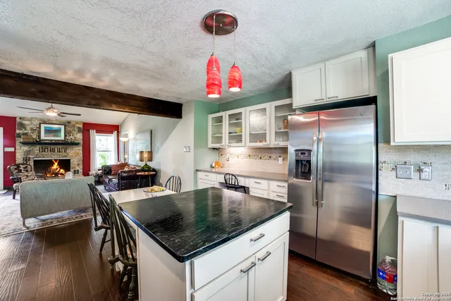 a kitchen with kitchen island a counter top a stove and a refrigerator