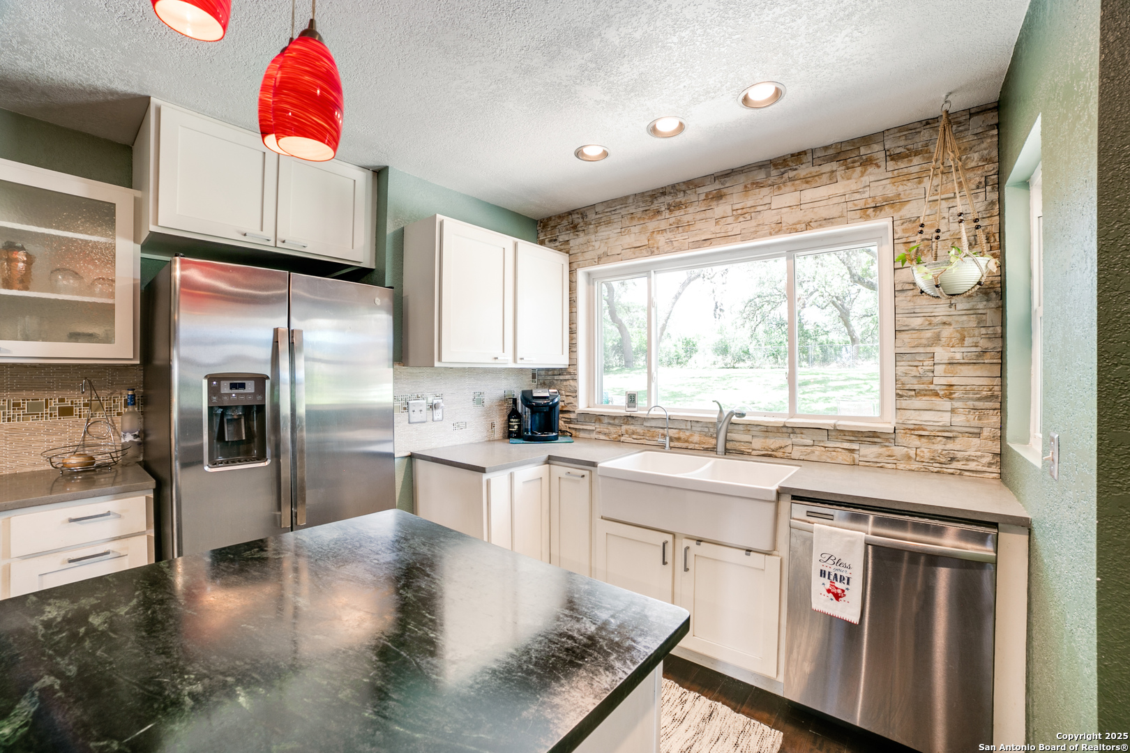 20892 Bluehill Pass Helotes, TX 78023 - Photo 6 of 36 a kitchen that has a lot of white cabinets and stainless steel appliances