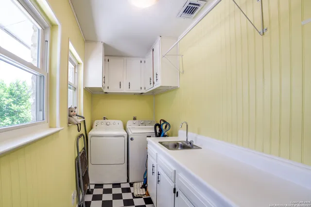 a utility room with a sink a washer and dryer