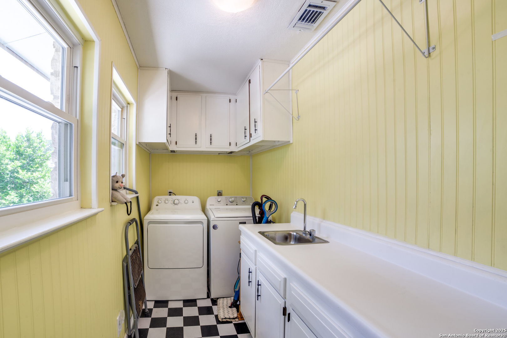 20892 Bluehill Pass Helotes, TX 78023 - Photo 10 of 36 a utility room with a sink a washer and dryer