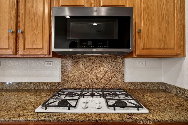 a front view of a house with a garden and trees