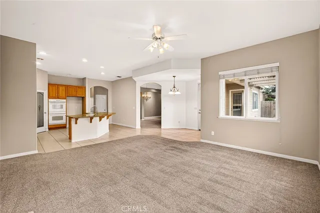 a view of an empty room with a ceiling fan