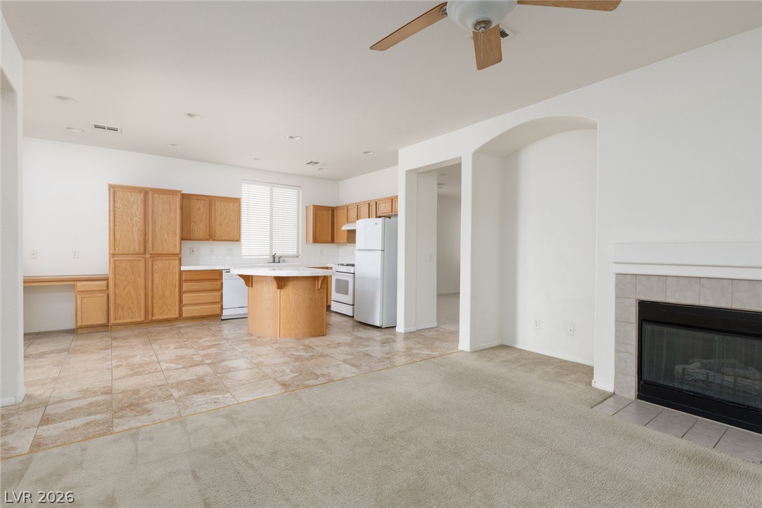 787 Rise Canyon Drive Henderson, NV 89052 - Photo 3 of 22 An open concept living area transitions seamlessly to a well-appointed kitchen, ideal for daily living.