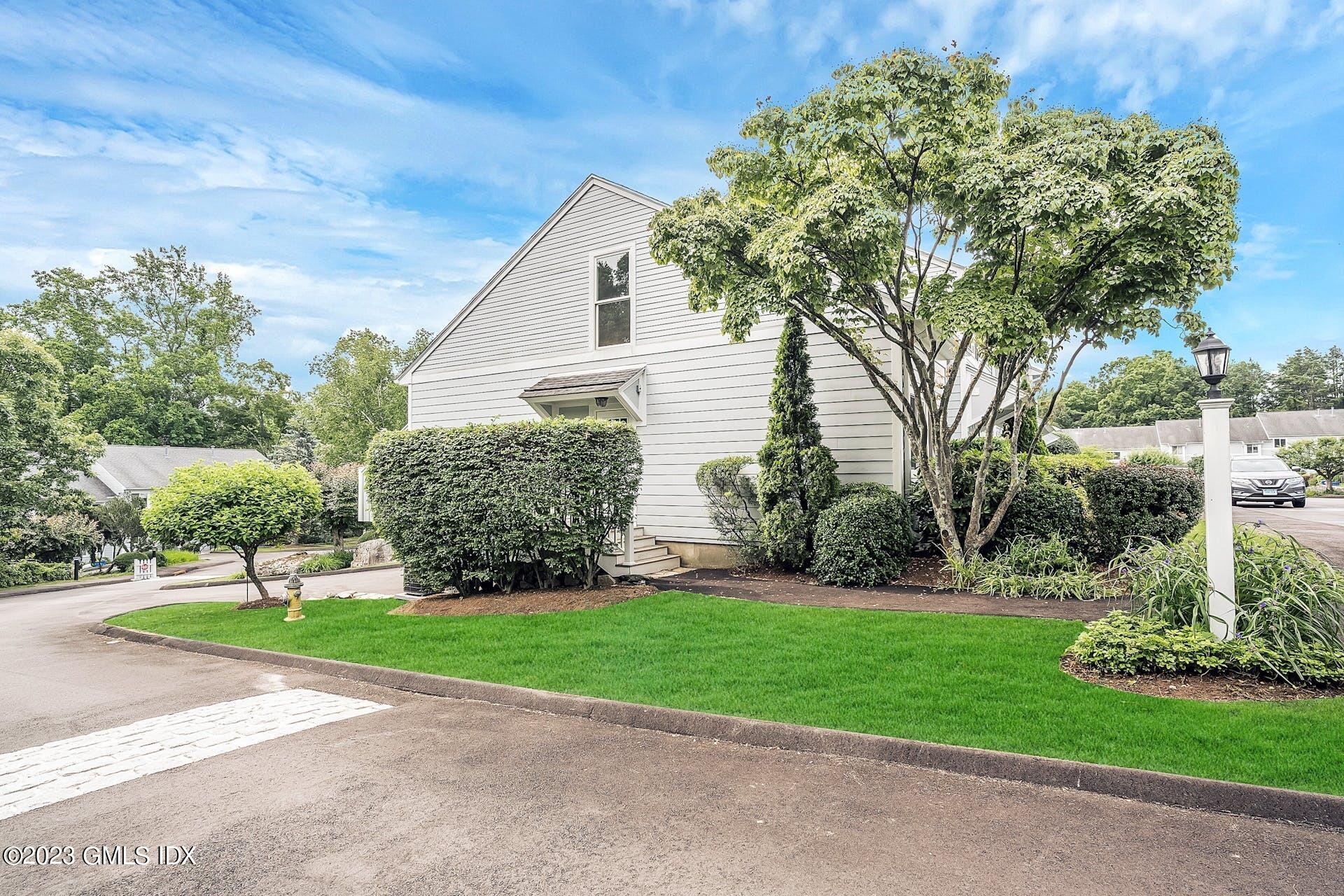 2 Whiffletree Way, Unit 2 Riverside, CT 06878 - Photo 1 of 16 a front view of a house with a yard