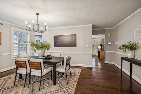 a view of a dining room with furniture and a potted plant
