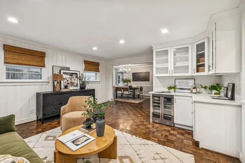 a kitchen with a refrigerator and a chair